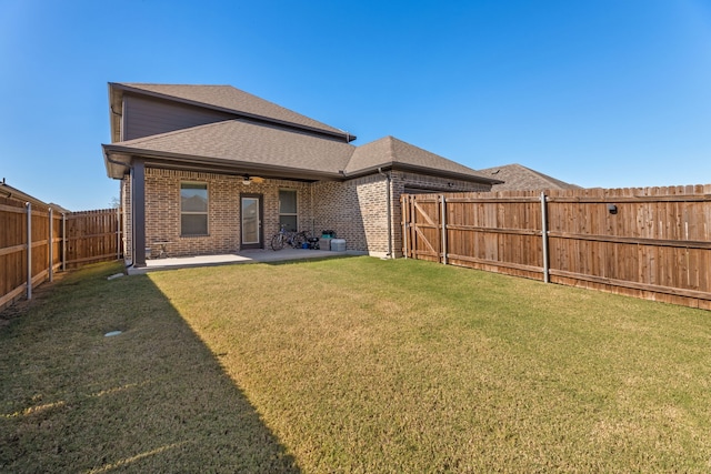 back of house featuring a patio and a yard