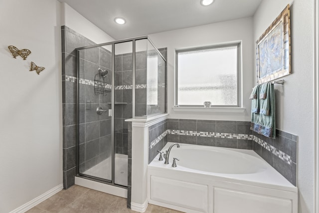 bathroom featuring tile patterned floors and separate shower and tub