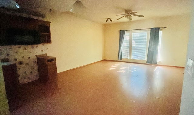 unfurnished living room with ceiling fan and a textured ceiling