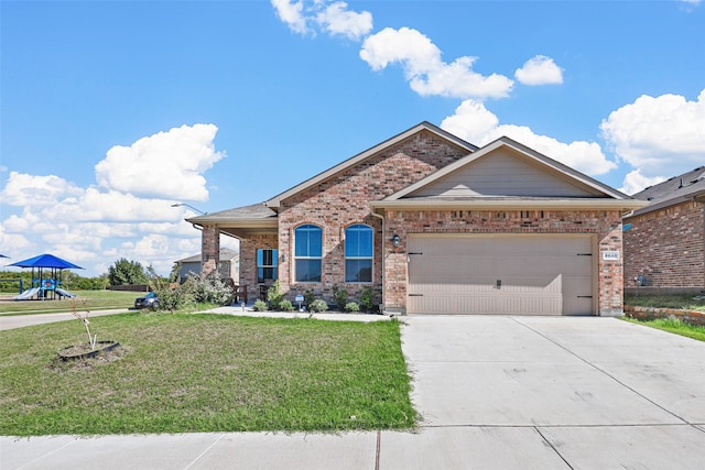 view of front of home featuring a front yard and a garage