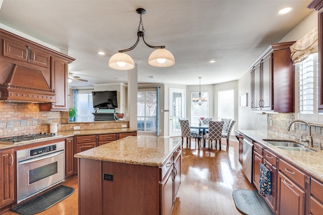 kitchen with a wealth of natural light, stainless steel appliances, and a kitchen island