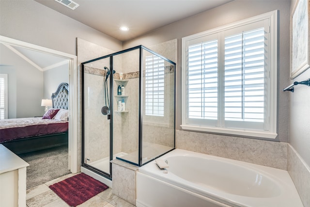 bathroom with independent shower and bath and tile patterned flooring