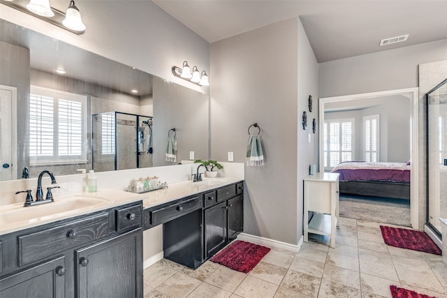 bathroom featuring walk in shower, a wealth of natural light, and vanity