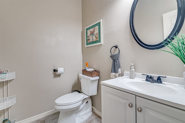 bathroom with vanity, tile patterned floors, and toilet