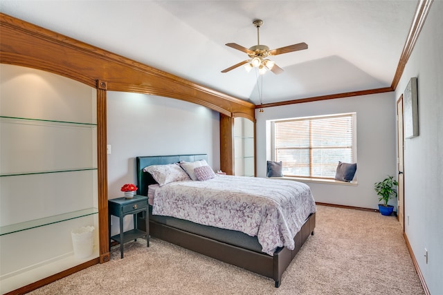 carpeted bedroom with ornamental molding, ceiling fan, and vaulted ceiling