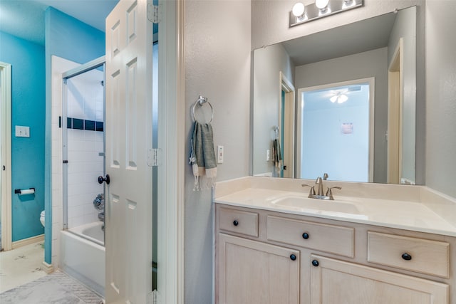 full bathroom featuring enclosed tub / shower combo, toilet, and vanity