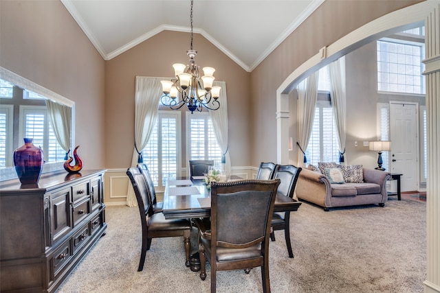 dining area with a healthy amount of sunlight, ornamental molding, and light carpet