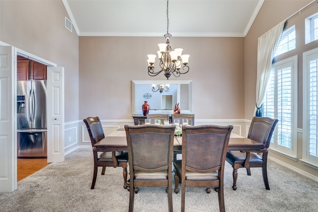 dining room featuring ornamental molding, light carpet, lofted ceiling, and a notable chandelier