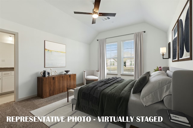 carpeted bedroom with ceiling fan, connected bathroom, and vaulted ceiling