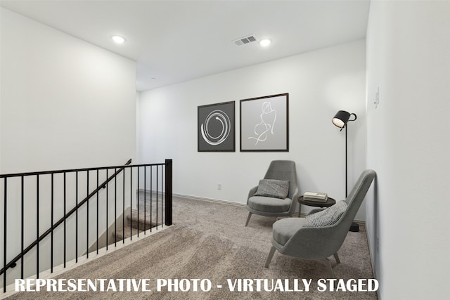 sitting room featuring carpet flooring