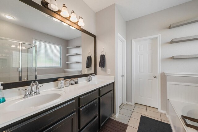 bathroom featuring tile patterned flooring, vanity, and separate shower and tub