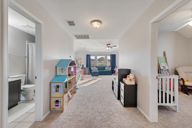 game room with ceiling fan and light carpet