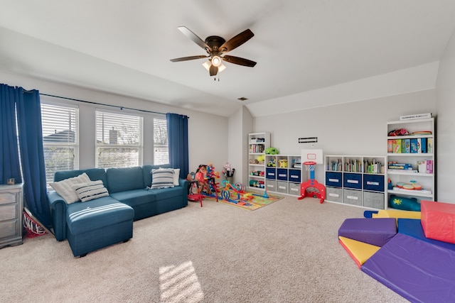 recreation room with ceiling fan, carpet floors, and vaulted ceiling