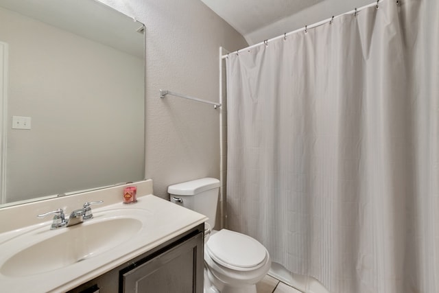 bathroom featuring tile patterned floors, vanity, toilet, and walk in shower