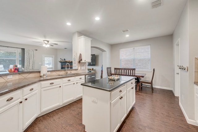 kitchen with white cabinets, sink, kitchen peninsula, and dark wood-type flooring