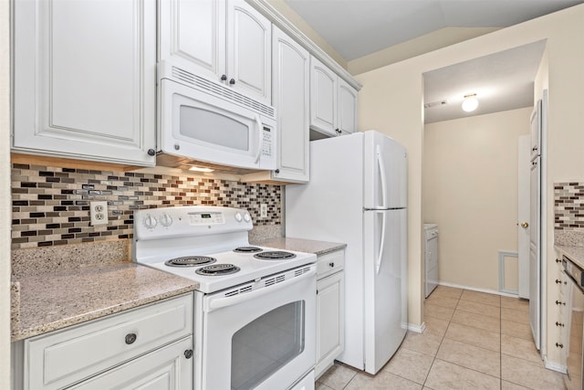 kitchen with lofted ceiling, light stone counters, white cabinets, tasteful backsplash, and white appliances