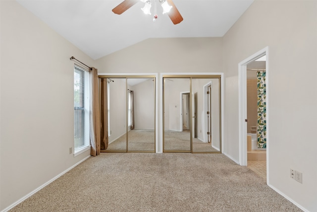 unfurnished bedroom featuring lofted ceiling, ceiling fan, and light carpet