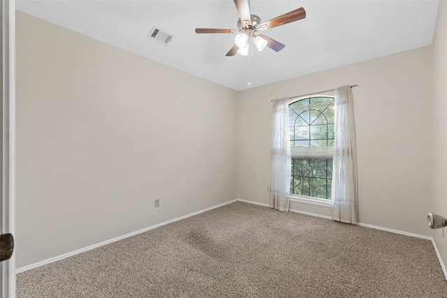 empty room featuring carpet floors and ceiling fan