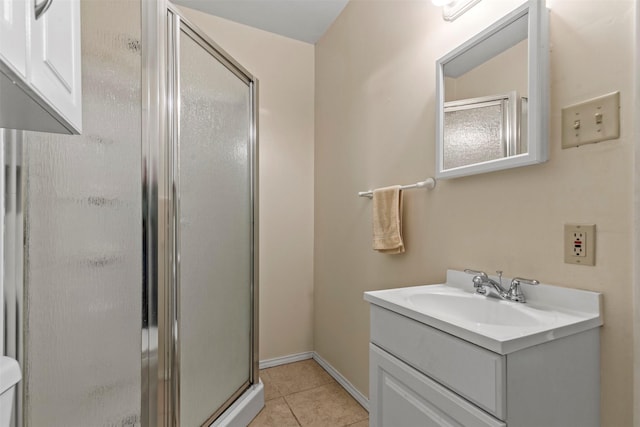 bathroom with vanity, an enclosed shower, and tile patterned flooring