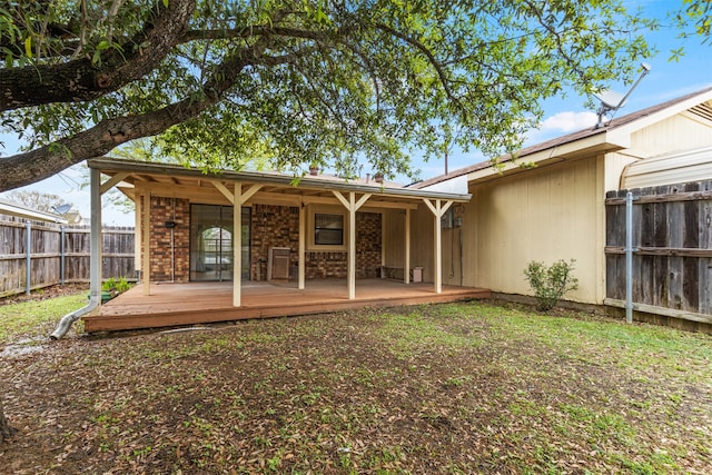 rear view of house featuring a wooden deck