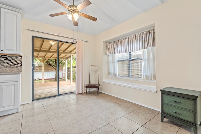 interior space with light tile patterned flooring and ceiling fan