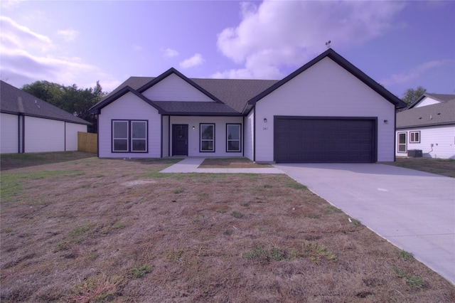 ranch-style house with a garage and central air condition unit