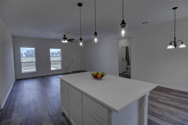 kitchen featuring a center island, white cabinets, dark hardwood / wood-style flooring, and decorative light fixtures