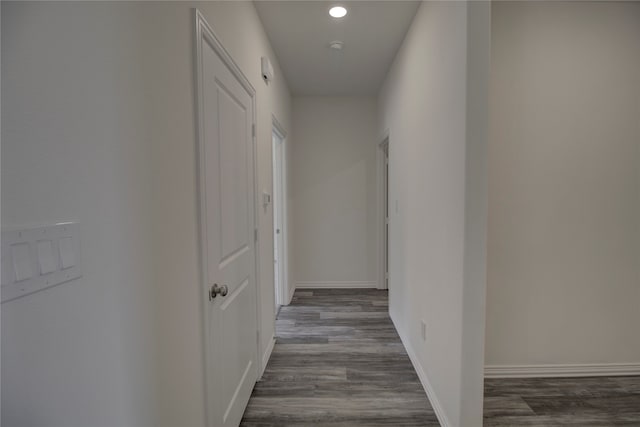 hallway with dark wood-type flooring