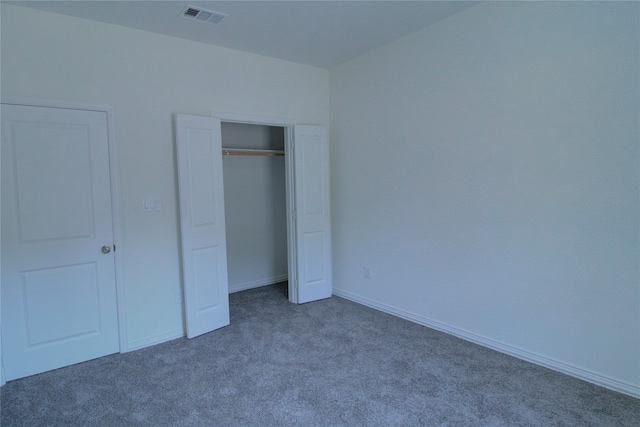 unfurnished bedroom with carpet floors and a closet