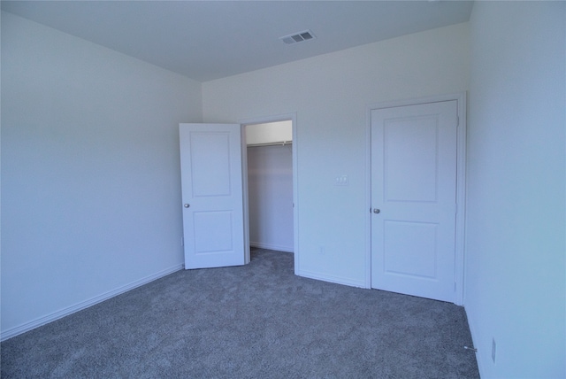 unfurnished bedroom with dark carpet