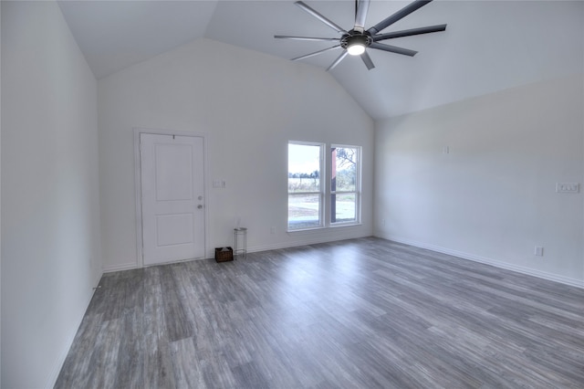 unfurnished living room with vaulted ceiling, dark hardwood / wood-style floors, and ceiling fan