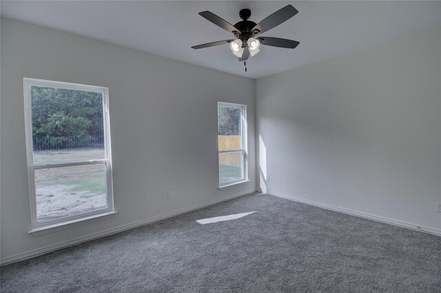 carpeted spare room with ceiling fan