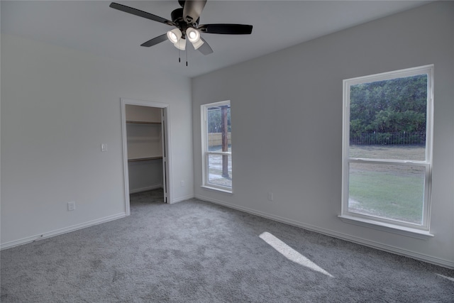 spare room with carpet floors and ceiling fan