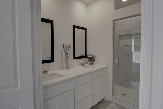 bathroom with vanity and a shower with shower door