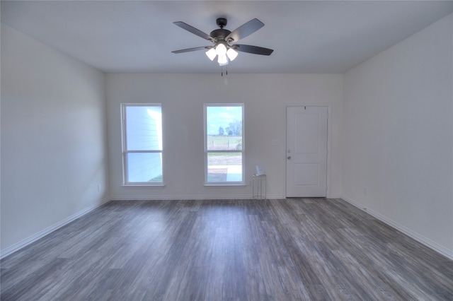 empty room featuring ceiling fan and dark hardwood / wood-style flooring