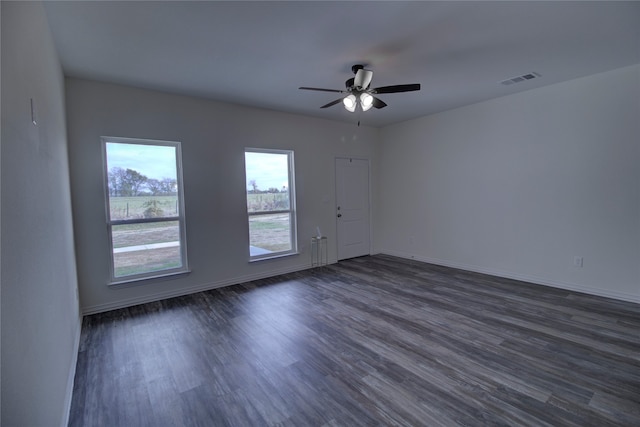 unfurnished room featuring ceiling fan and dark hardwood / wood-style flooring