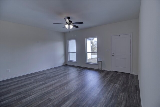 spare room featuring dark hardwood / wood-style floors and ceiling fan