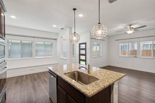 kitchen with dishwasher, decorative light fixtures, sink, and plenty of natural light