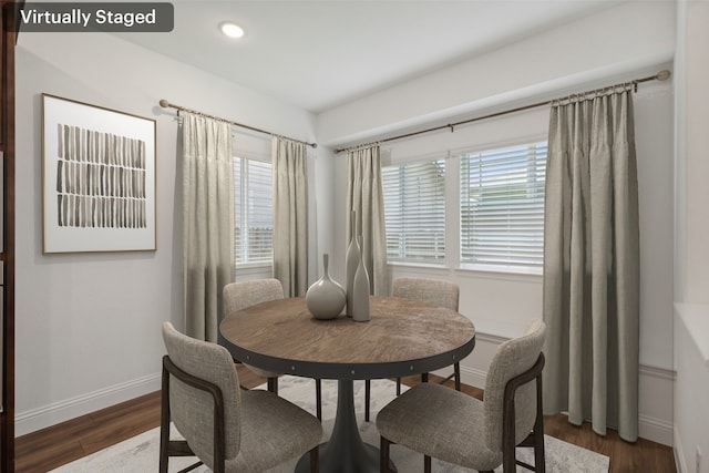 dining space with dark hardwood / wood-style flooring and plenty of natural light