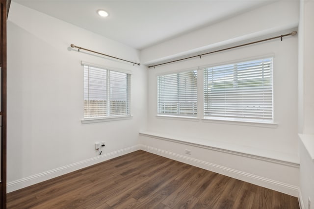 unfurnished room with dark wood-type flooring