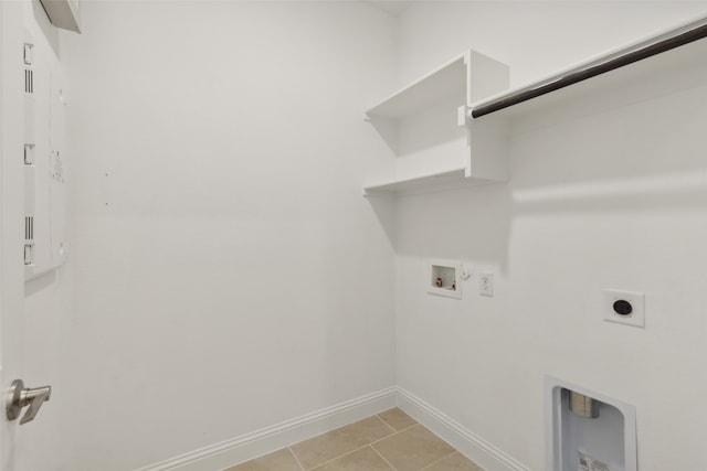 washroom with hookup for an electric dryer, gas dryer hookup, hookup for a washing machine, and light tile patterned floors