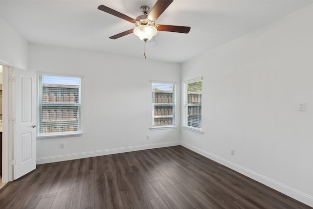 spare room featuring dark hardwood / wood-style flooring and ceiling fan