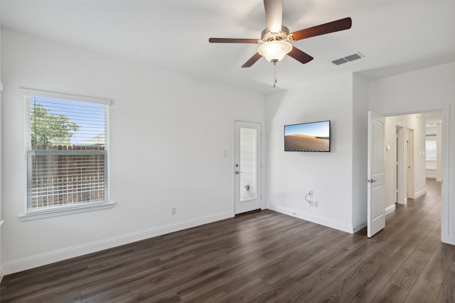 unfurnished living room with dark hardwood / wood-style flooring and ceiling fan