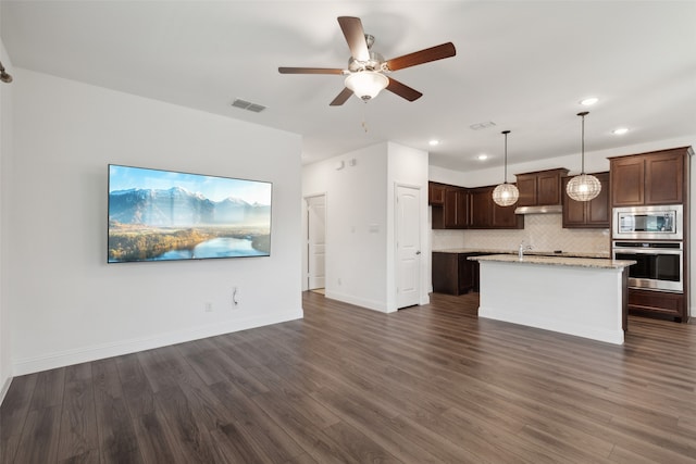 kitchen featuring hanging light fixtures, dark hardwood / wood-style flooring, and appliances with stainless steel finishes