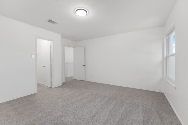 unfurnished room with light carpet