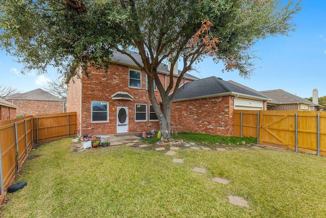 rear view of property with a yard