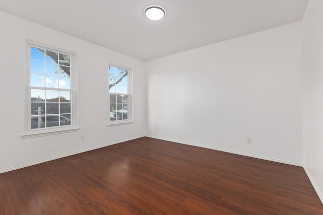 empty room with dark wood-type flooring