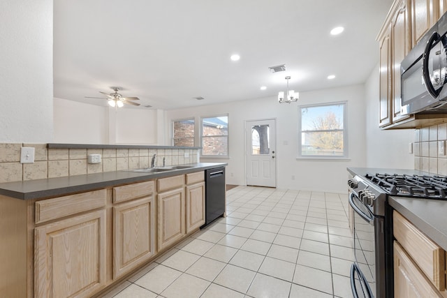 kitchen with decorative backsplash, ceiling fan with notable chandelier, stainless steel appliances, light tile patterned floors, and hanging light fixtures