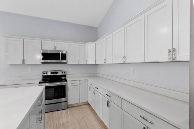 kitchen featuring white cabinets, stainless steel appliances, and light hardwood / wood-style flooring