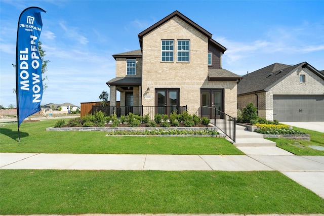 view of front of house with a garage and a front yard